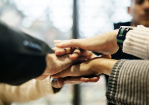 Diverse people stacking hands together Diverse people stacking hands together
